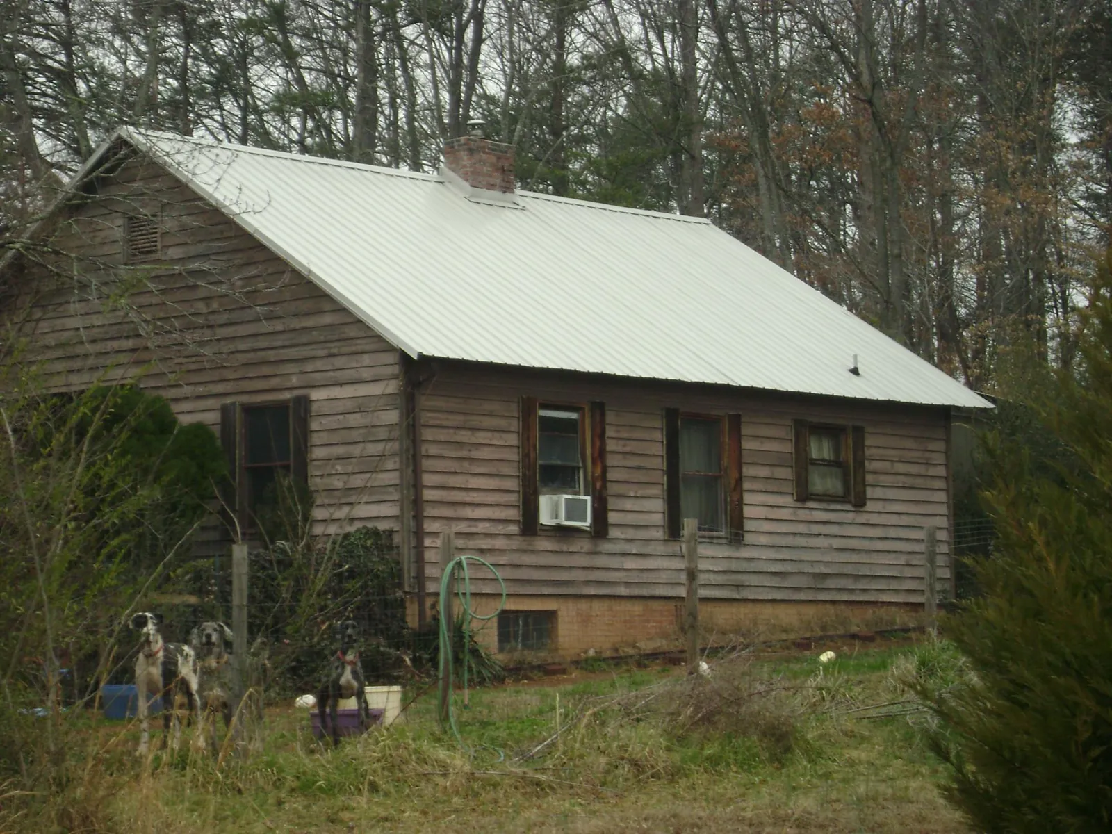 White metal roof on an old wood sided farmhouse, from a Metal Roof Installation job in Harlingen